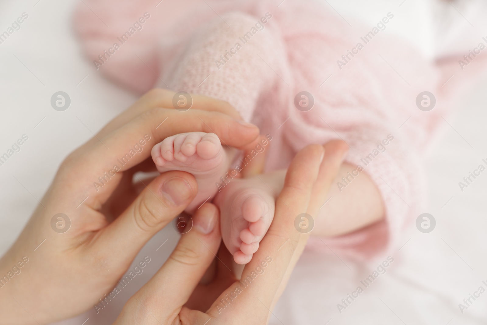 Mother with her little baby on bed indoors, closeup Photo of Mother with her little baby on bed indoors, closeup