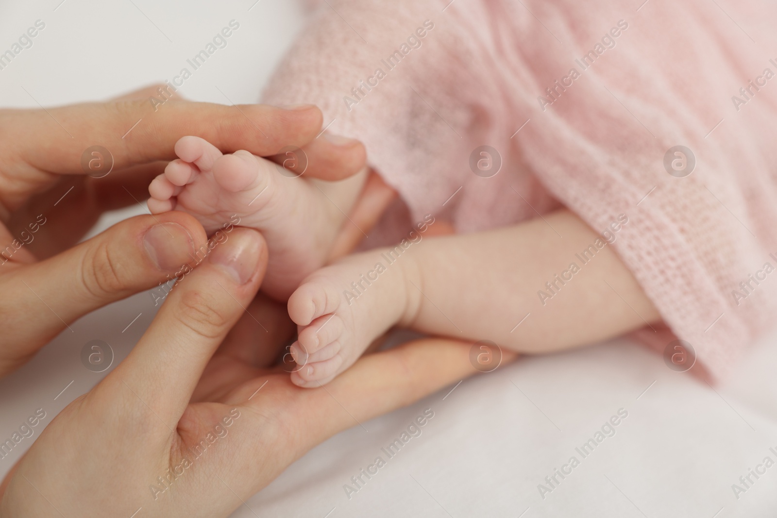 Mother with her little baby on bed indoors, closeup Photo of Mother with her little baby on bed indoors, closeup