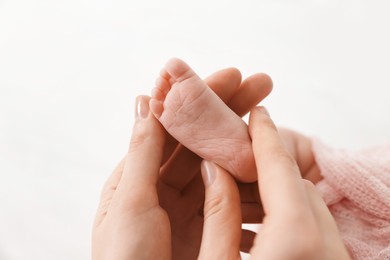 Photo of Mother with her little baby on bed indoors, closeup