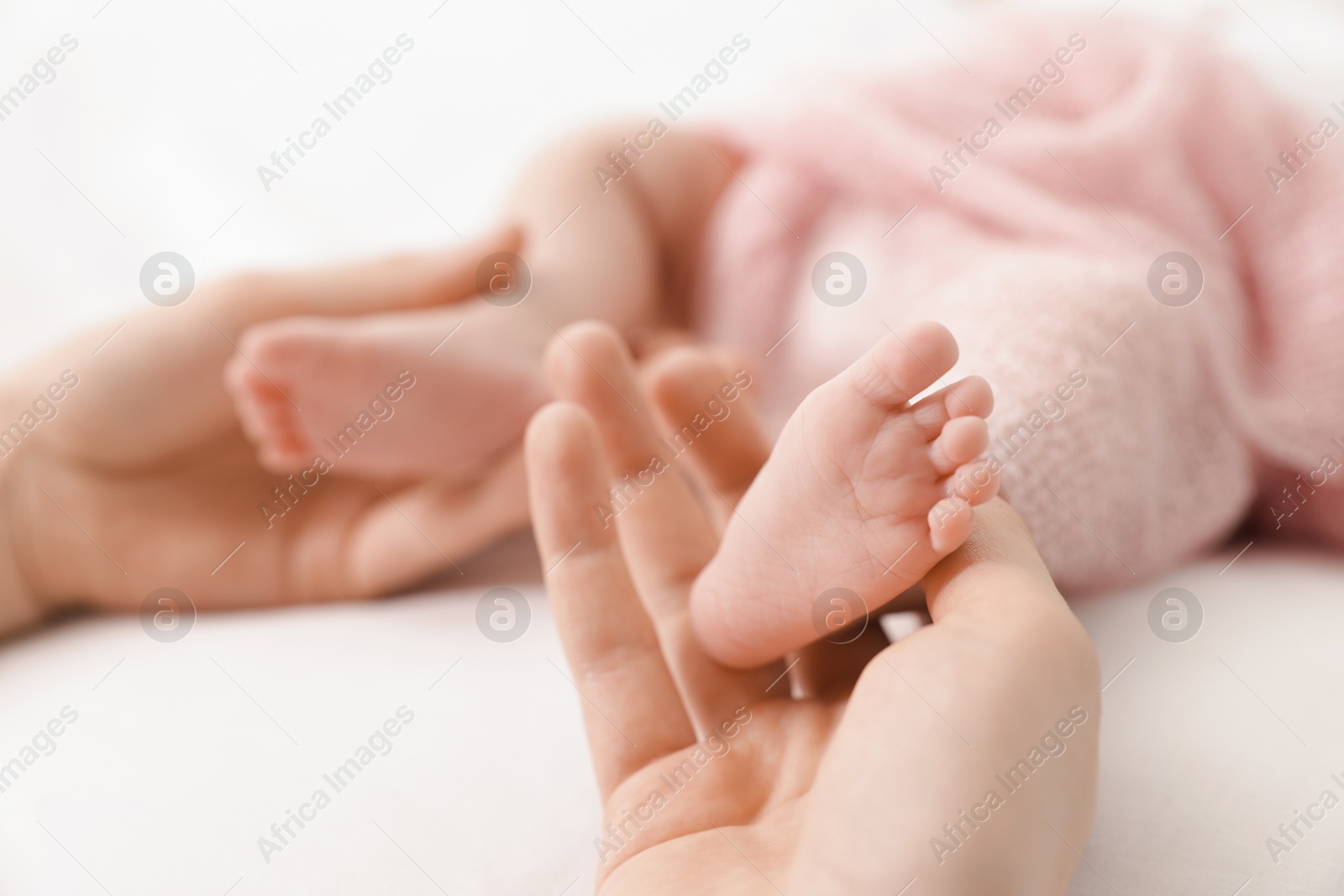 Mother with her little baby on bed indoors, closeup Photo of Mother with her little baby on bed indoors, closeup