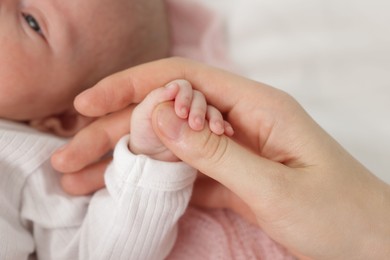 Photo of Mother with her little baby on bed indoors, closeup