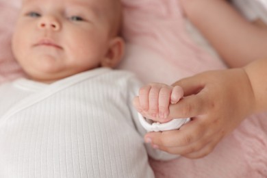 Photo of Cute girl and her little sister on bed at home, closeup