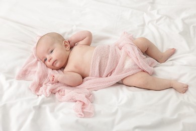 Photo of Cute little baby lying on bed at home