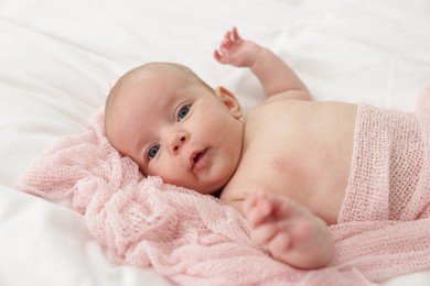 Photo of Cute little baby lying on bed at home