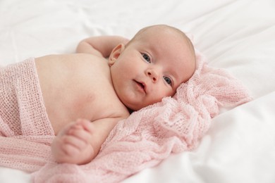 Photo of Cute little baby lying on bed at home