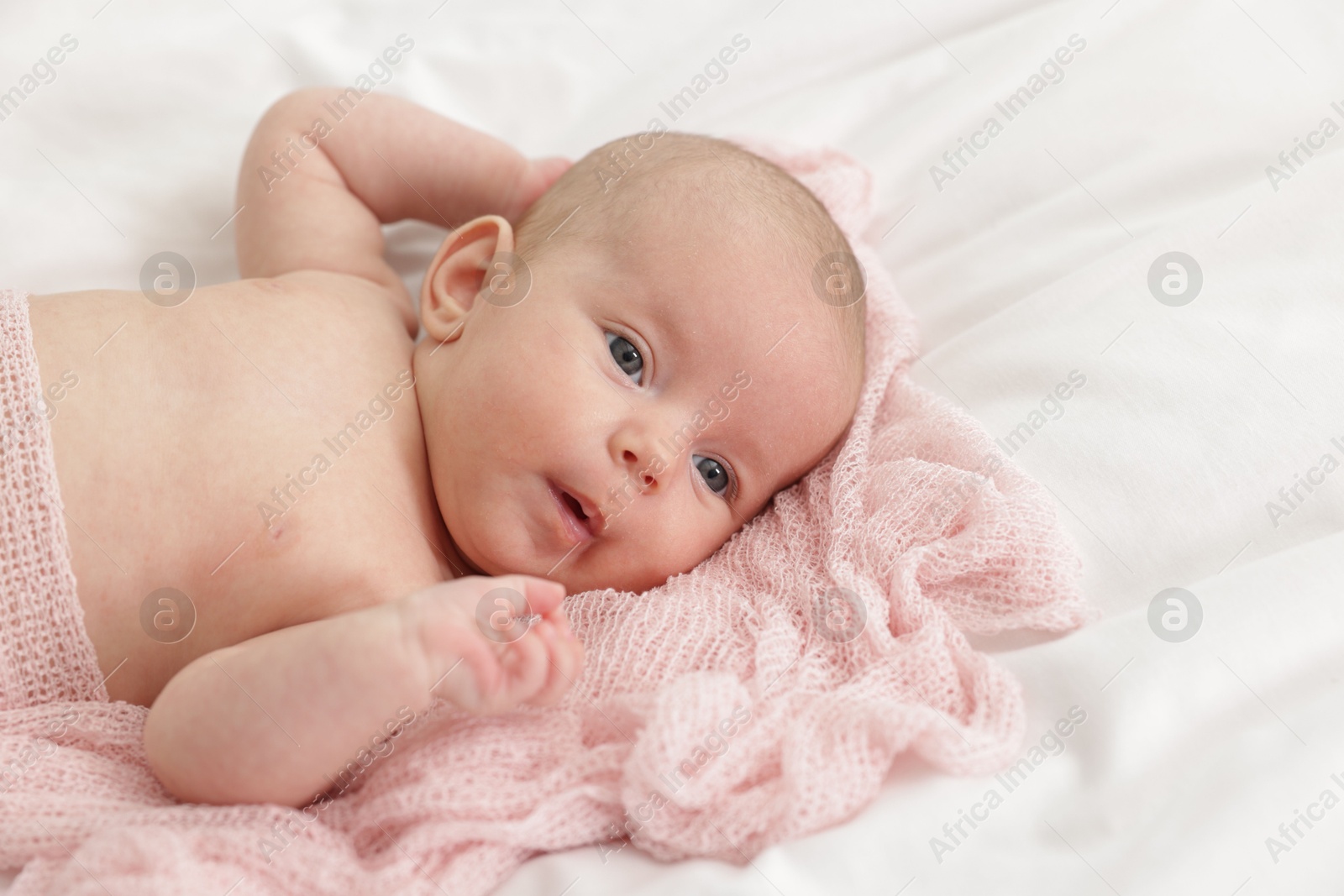 Cute little baby lying on bed at home Photo of Cute little baby lying on bed at home