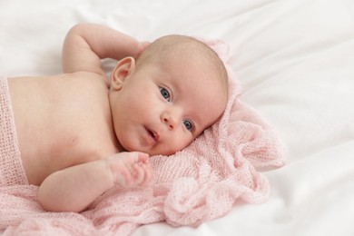 Photo of Cute little baby lying on bed at home