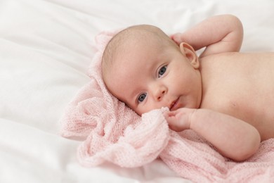 Photo of Cute little baby lying on bed at home