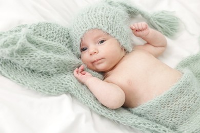 Photo of Cute little baby lying on bed at home