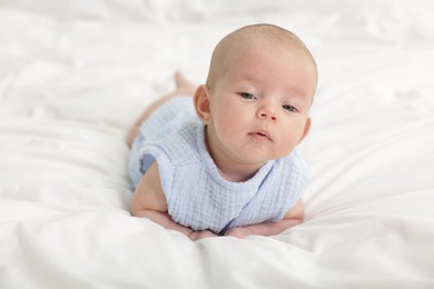 Photo of Cute little baby on bed at home