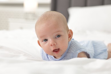 Photo of Cute little baby on bed at home