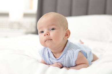 Photo of Cute little baby on bed at home