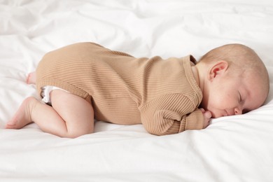 Photo of Cute little baby sleeping on bed at home