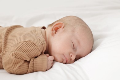 Photo of Cute little baby sleeping on bed at home
