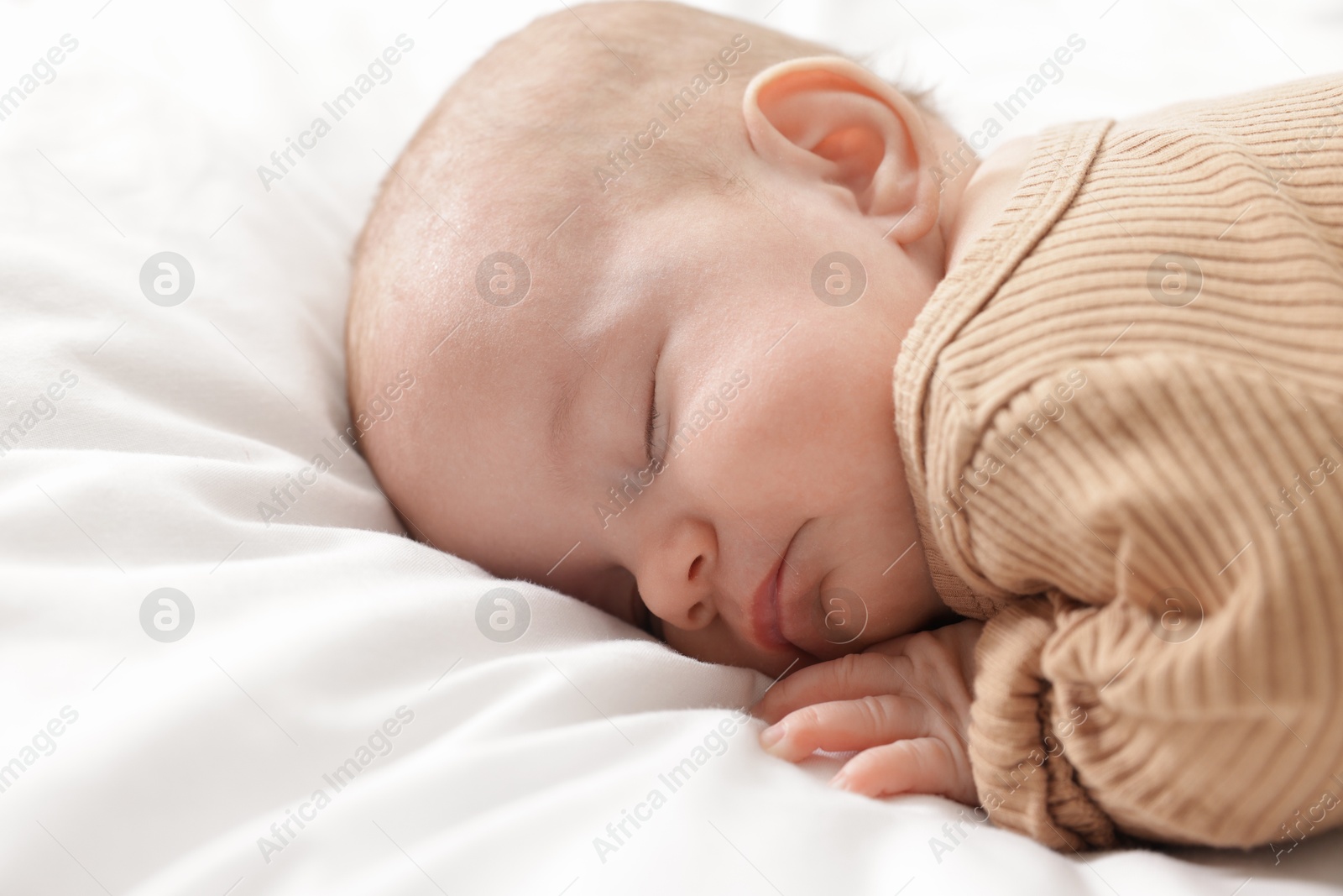 Cute little baby sleeping on bed at home Photo of Cute little baby sleeping on bed at home