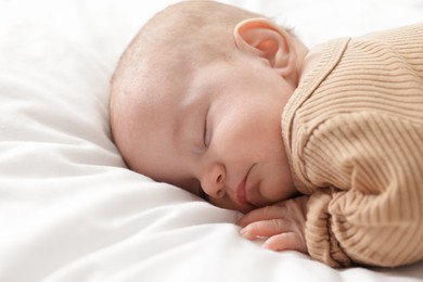 Photo of Cute little baby sleeping on bed at home