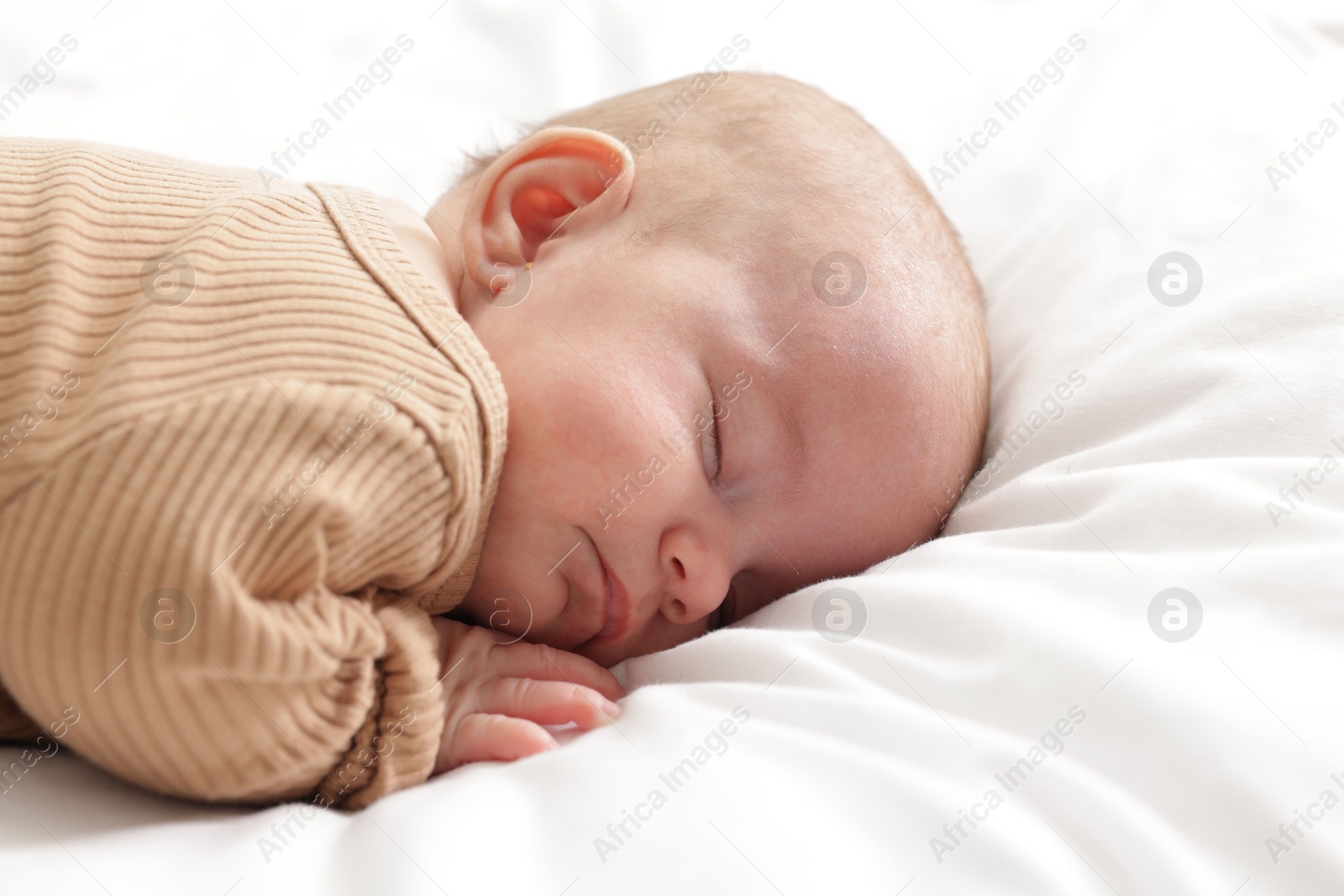 Cute little baby sleeping on bed at home Photo of Cute little baby sleeping on bed at home