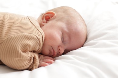 Photo of Cute little baby sleeping on bed at home
