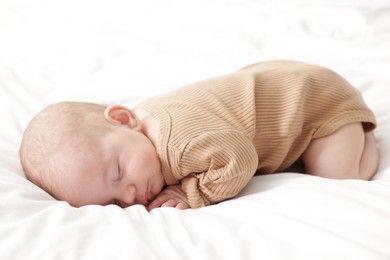Photo of Cute little baby sleeping on bed at home