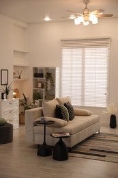 Photo of Comfortable sofa with cushions in room. Interior design