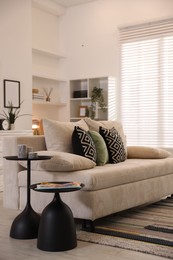 Photo of Comfortable sofa with cushions in room. Interior design