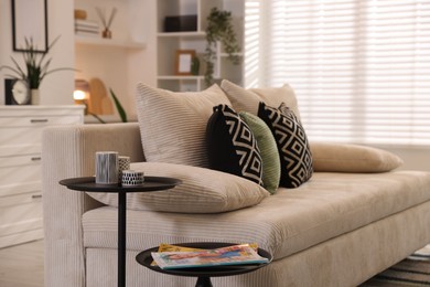 Photo of Comfortable sofa with cushions in room. Interior design