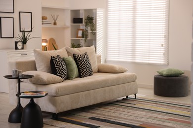 Photo of Comfortable sofa with cushions in room. Interior design