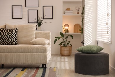 Photo of Comfortable sofa with cushions in room. Interior design