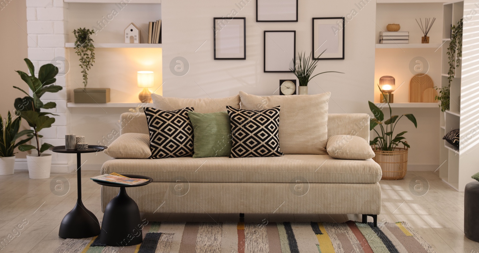 Comfortable sofa with cushions in room. Interior design Photo of Comfortable sofa with cushions in room. Interior design