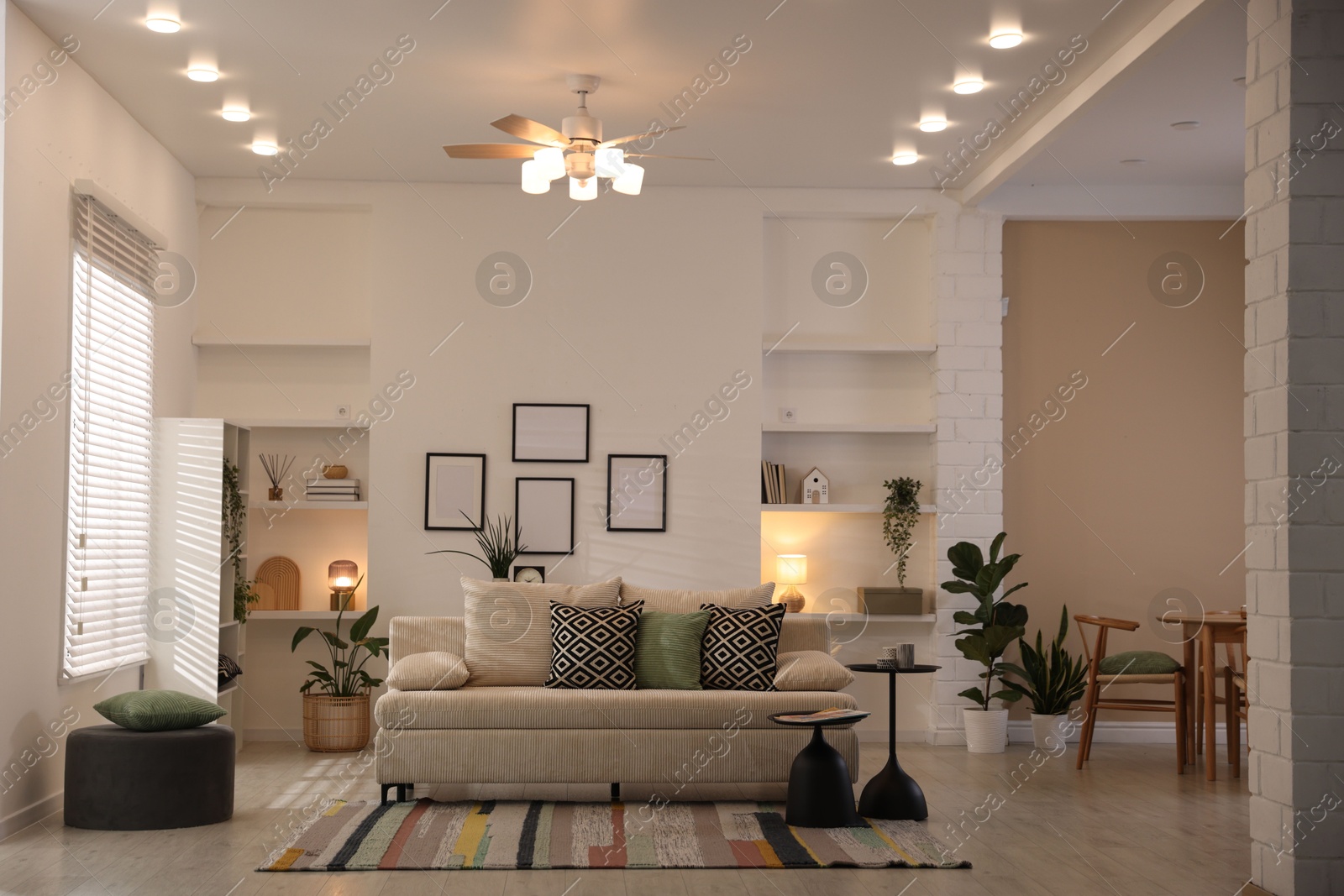 Comfortable sofa with cushions in room. Interior design Photo of Comfortable sofa with cushions in room. Interior design