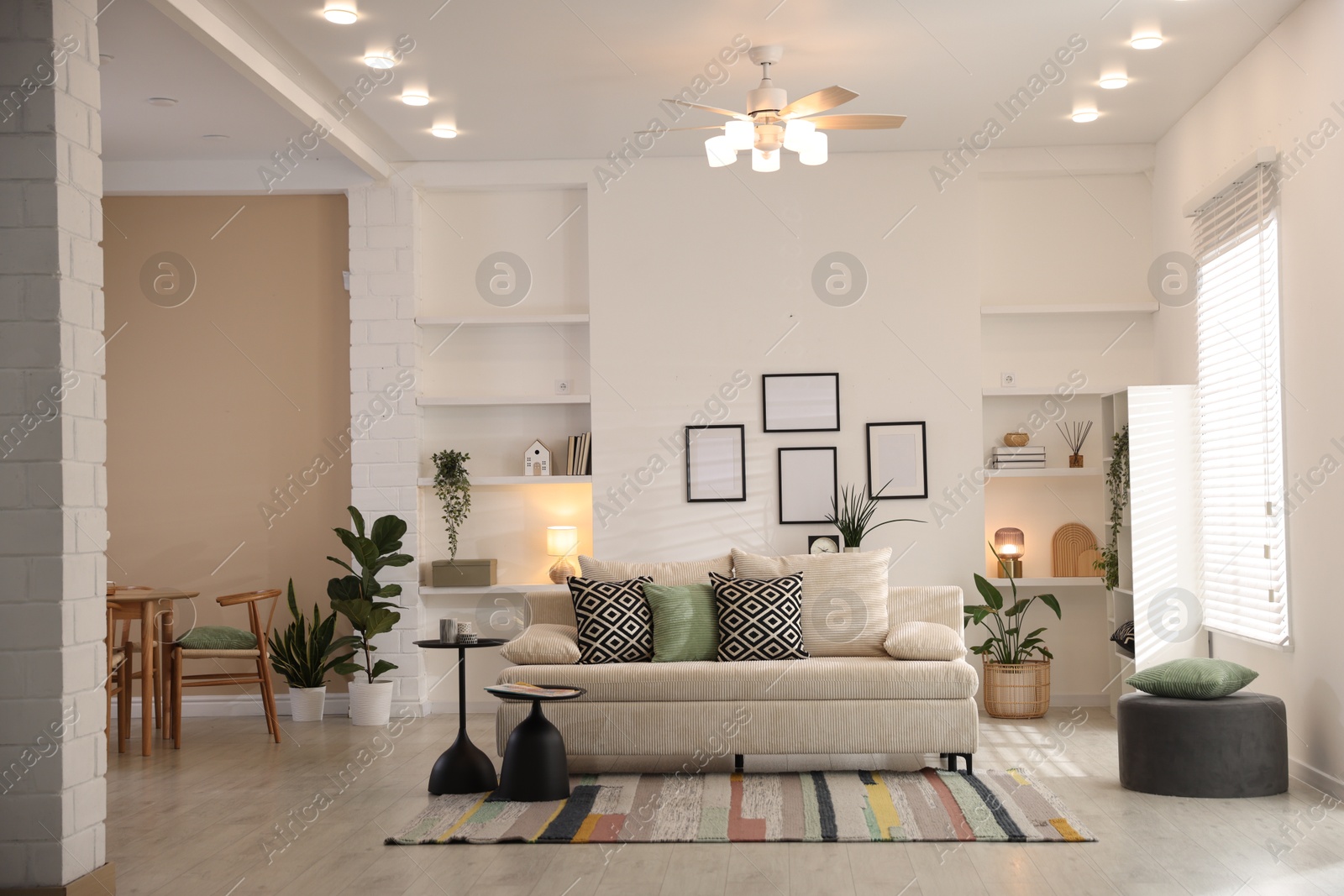 Comfortable sofa with cushions in room. Interior design Photo of Comfortable sofa with cushions in room. Interior design
