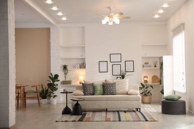 Photo of Comfortable sofa with cushions in room. Interior design