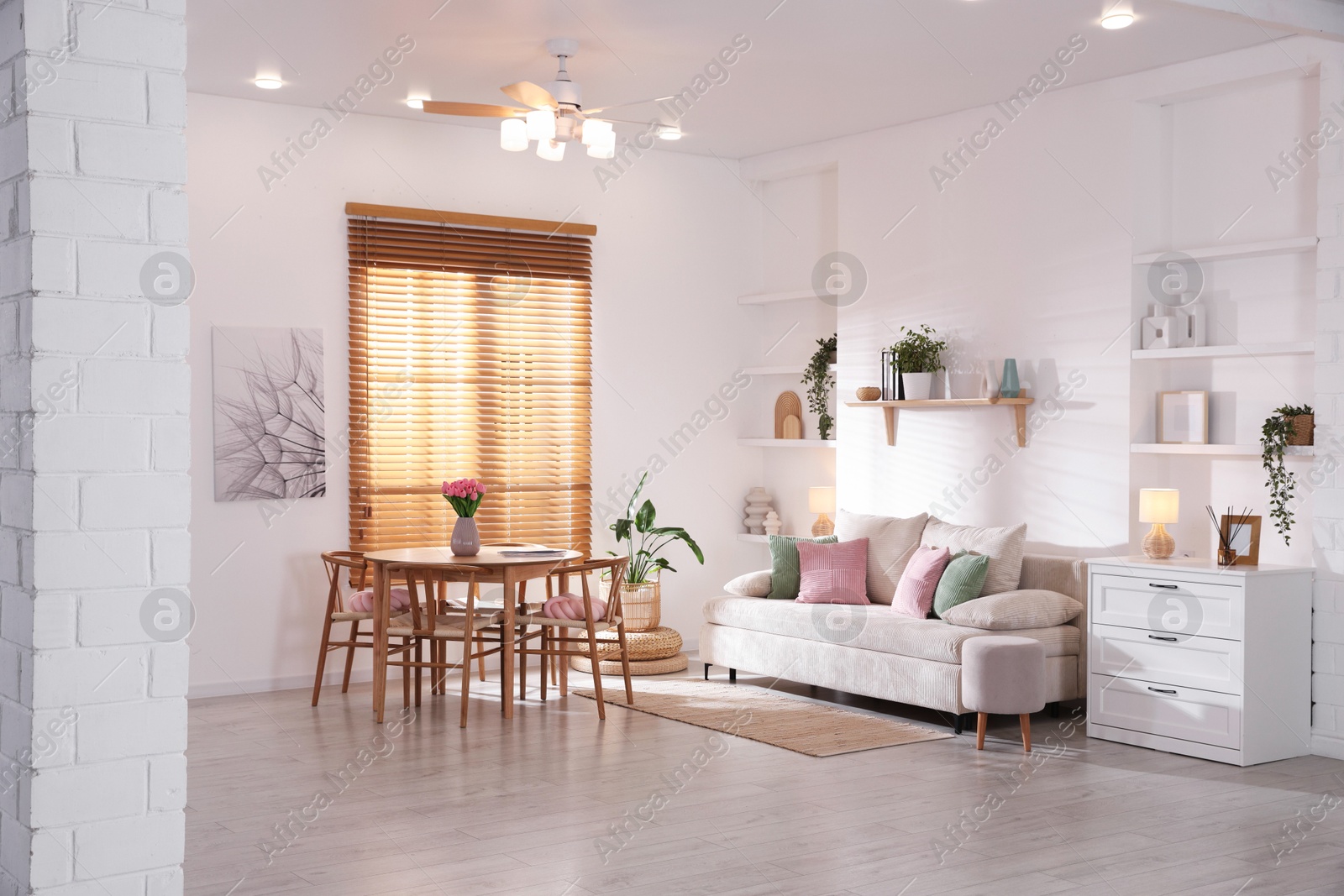 Stylish dining table with chairs and comfortable sofa in room. Interior design Photo of Stylish dining table with chairs and comfortable sofa in room. Interior design
