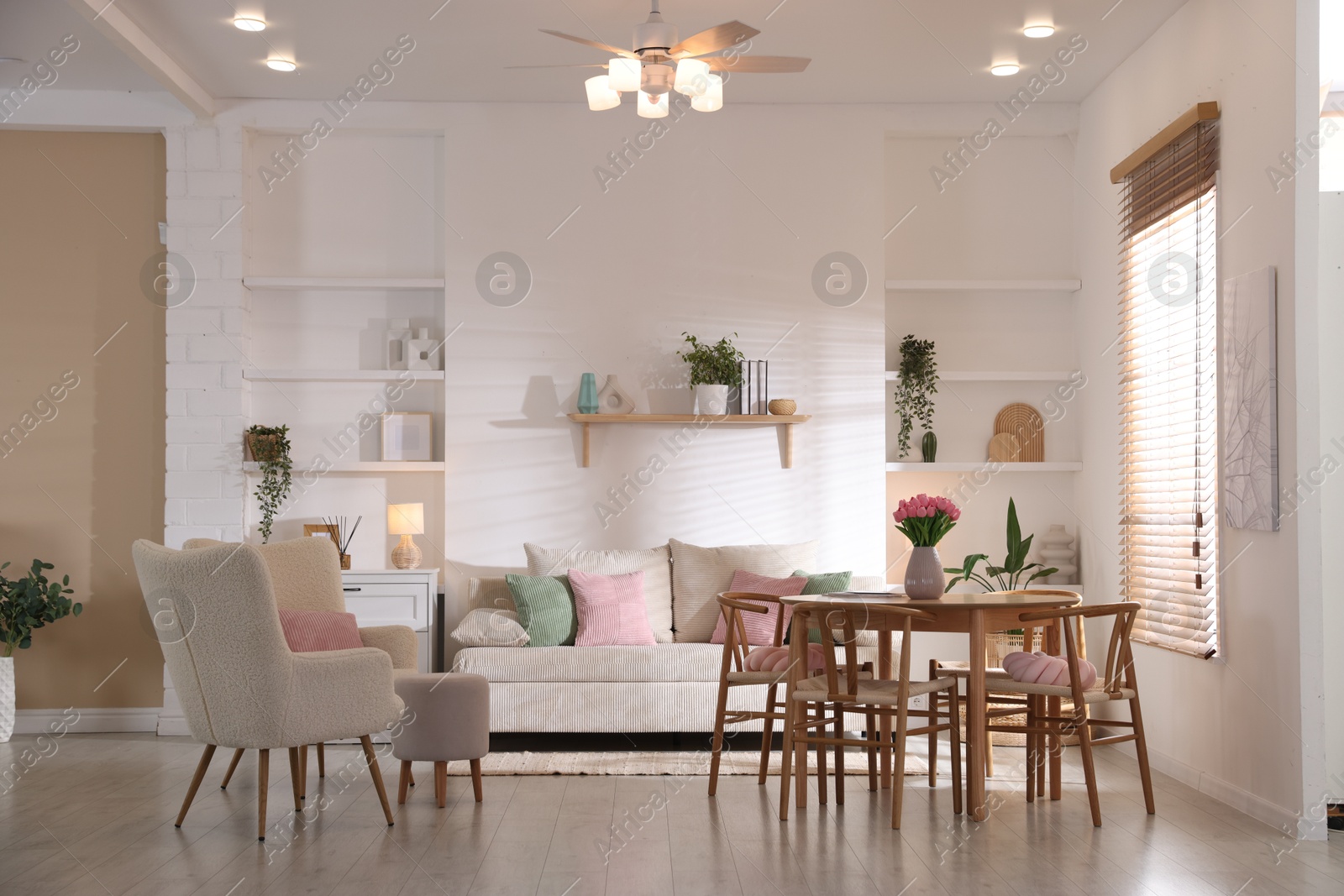 Stylish dining table with chairs and comfortable sofa in room. Interior design Photo of Stylish dining table with chairs and comfortable sofa in room. Interior design