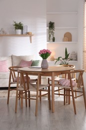 Photo of Stylish dining table with chairs in room. Interior design