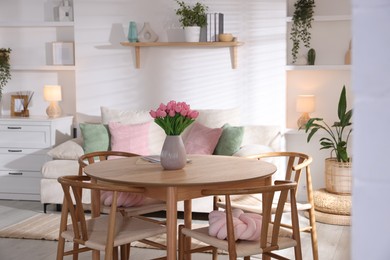 Photo of Stylish dining table with chairs in room. Interior design