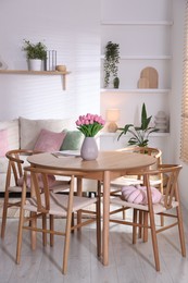 Photo of Stylish dining table with chairs in room. Interior design
