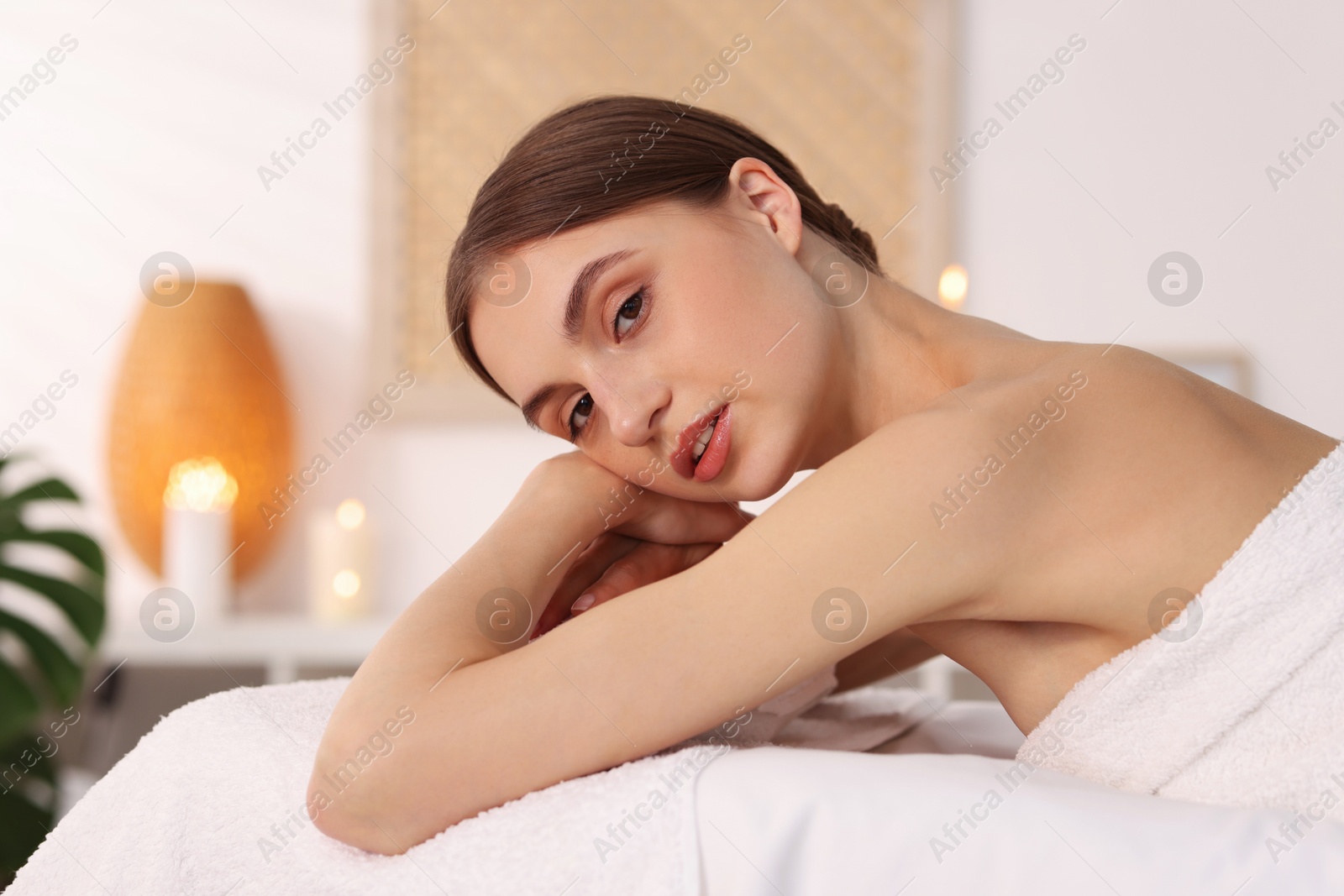 Portrait of beautiful woman on massage couch in spa salon Photo of Portrait of beautiful woman on massage couch in spa salon