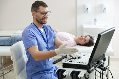 Photo of Sonographer showing woman her ultrasound imaging on screen in clinic