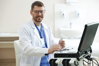 Photo of Professional sonographer with ultrasound machine in clinic