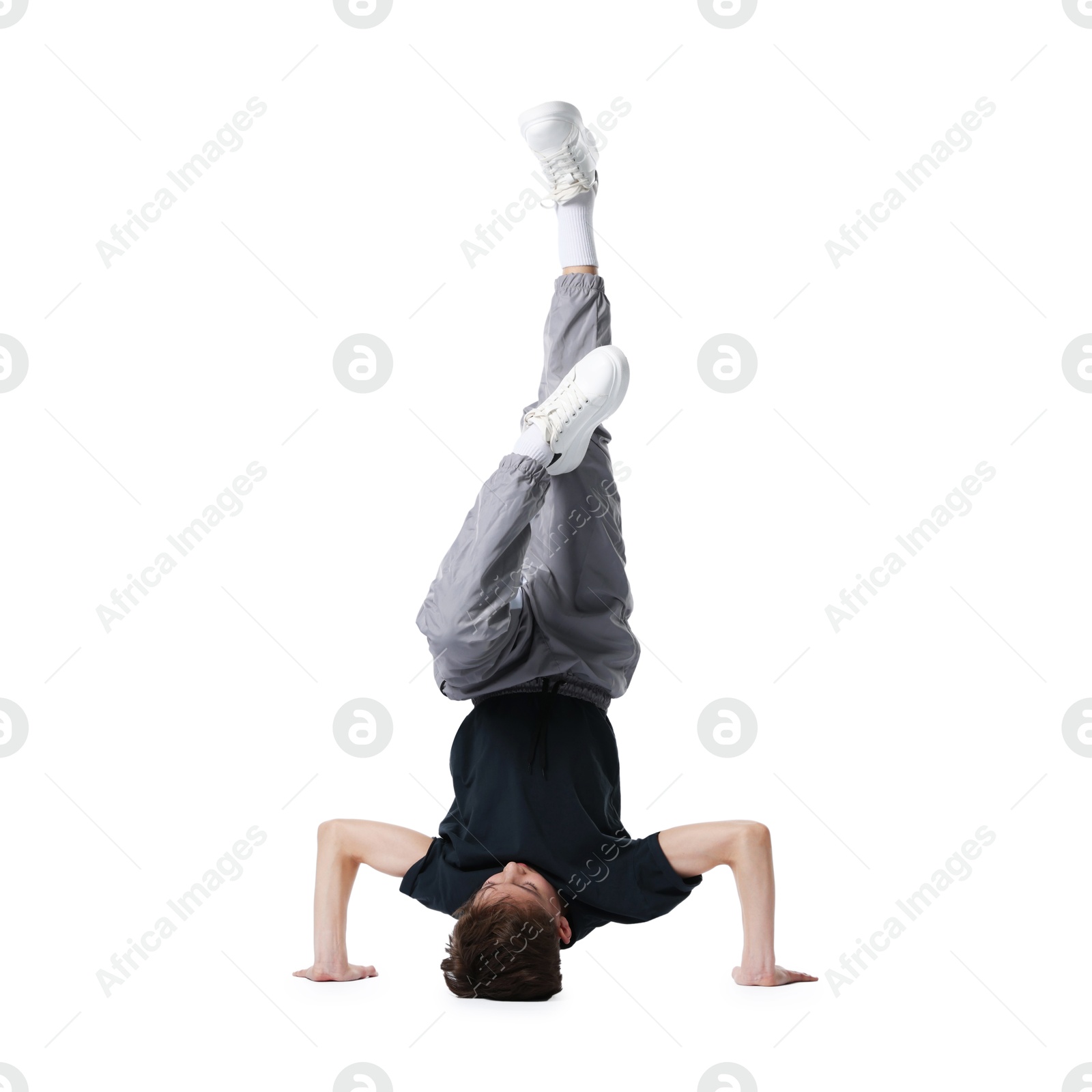 Boy in stylish clothes dancing on white background Photo of Boy in stylish clothes dancing on white background