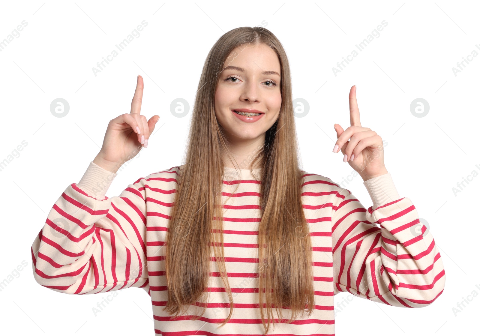 Teenage girl pointing at something on white background Photo of Teenage girl pointing at something on white background