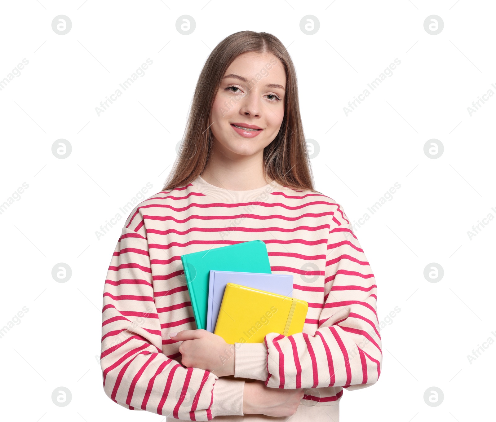 Teenage girl with notebooks on white background Photo of Teenage girl with notebooks on white background