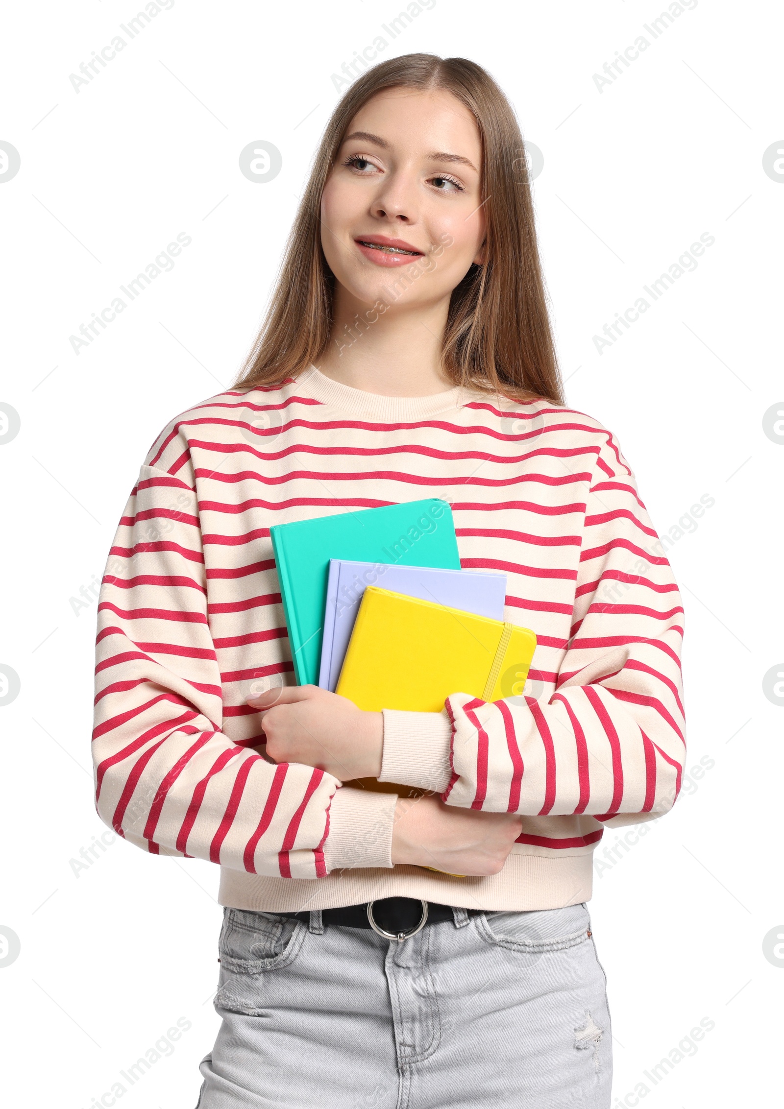 Teenage girl with notebooks on white background Photo of Teenage girl with notebooks on white background