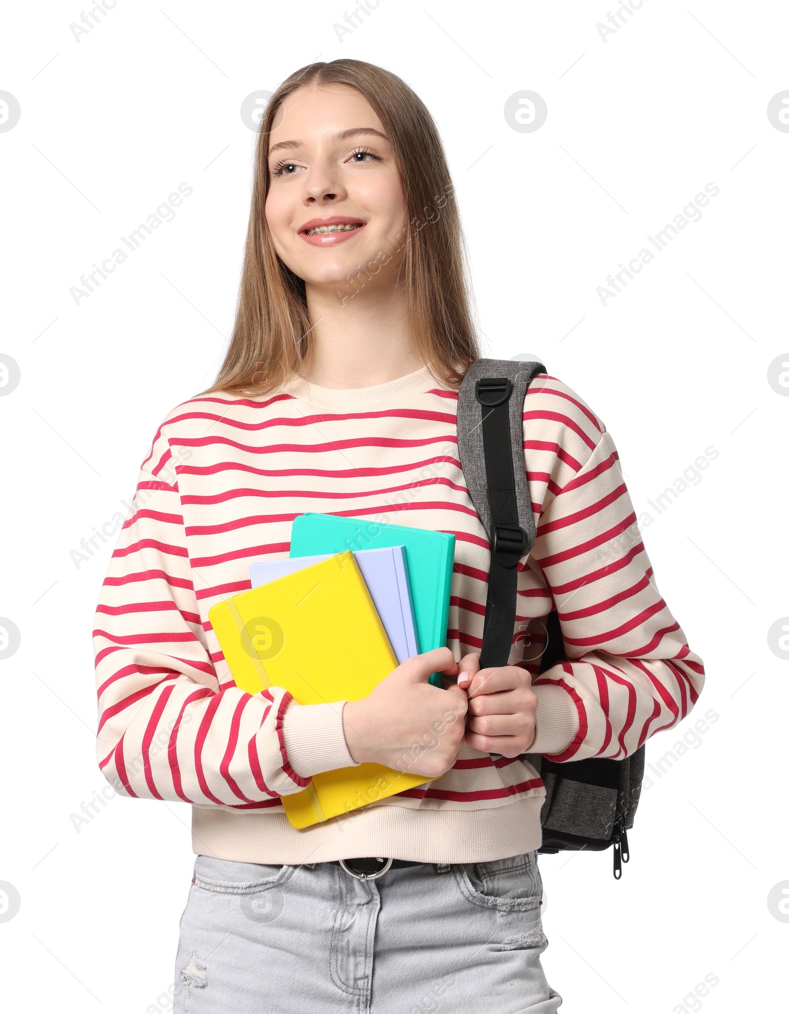Teenage girl with notebooks and backpack on white background Photo of Teenage girl with notebooks and backpack on white background