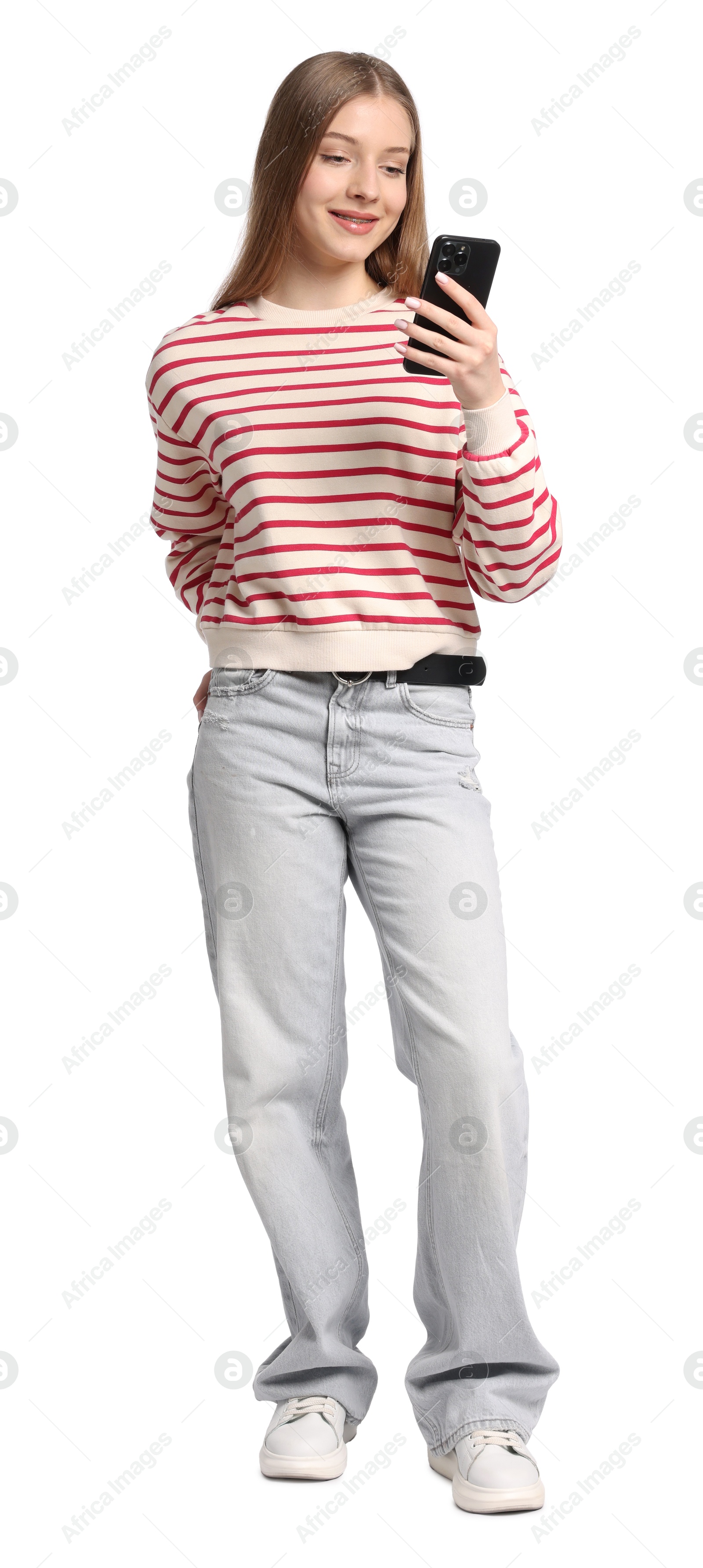 Teenage girl with smartphone on white background Photo of Teenage girl with smartphone on white background
