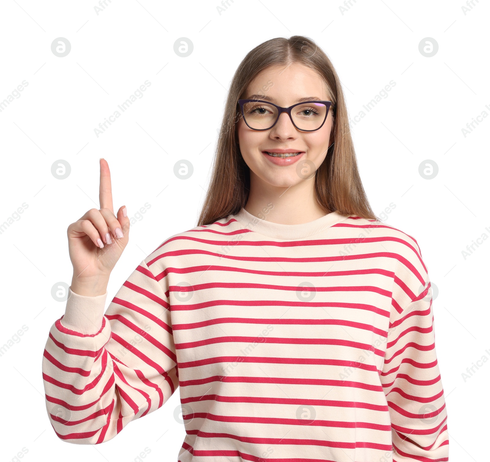 Teenage girl pointing at something on white background Photo of Teenage girl pointing at something on white background