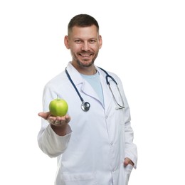 Photo of Nutritionist with green apple and stethoscope on white background
