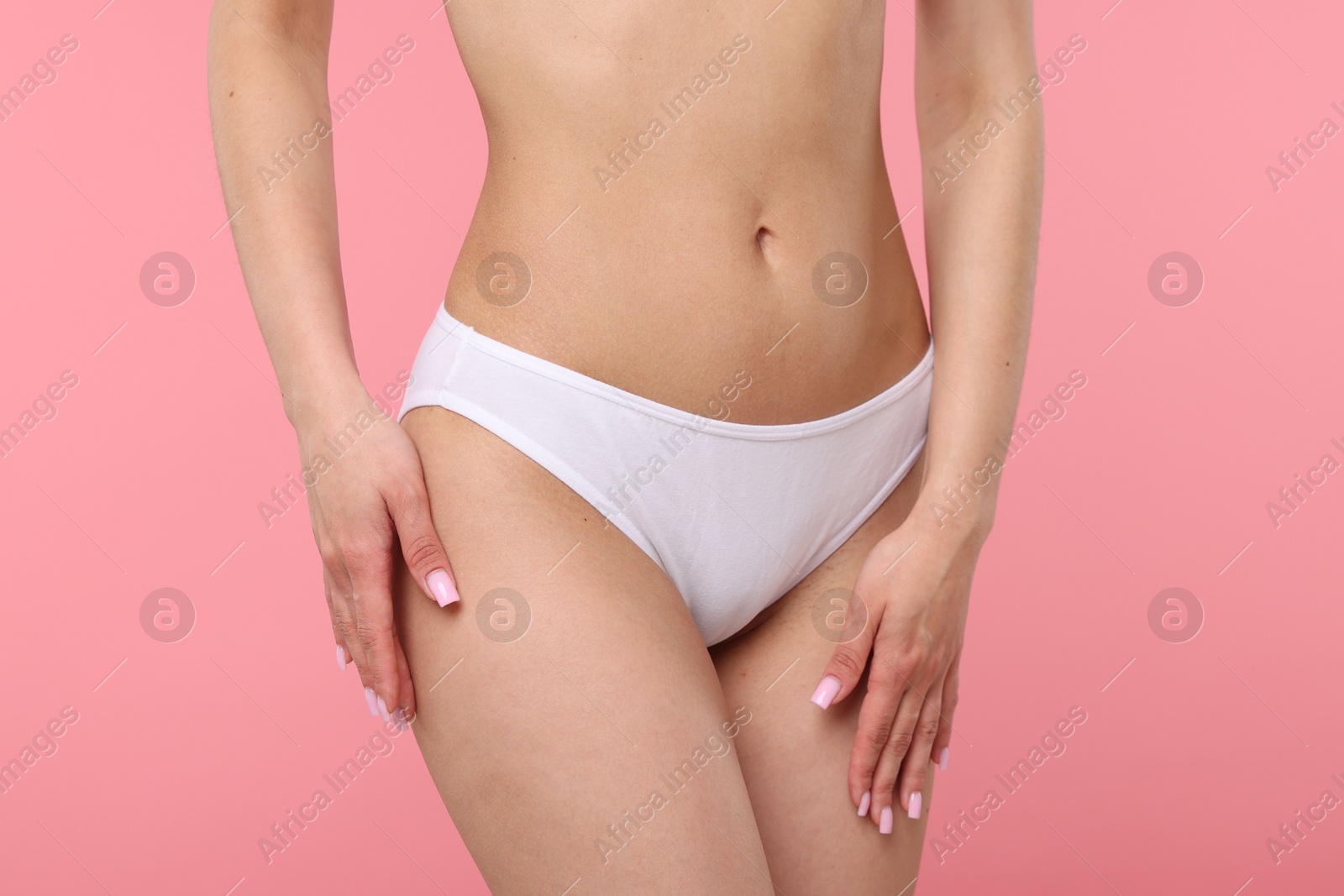 Woman with perfect slim body on pink background, closeup Photo of Woman with perfect slim body on pink background, closeup