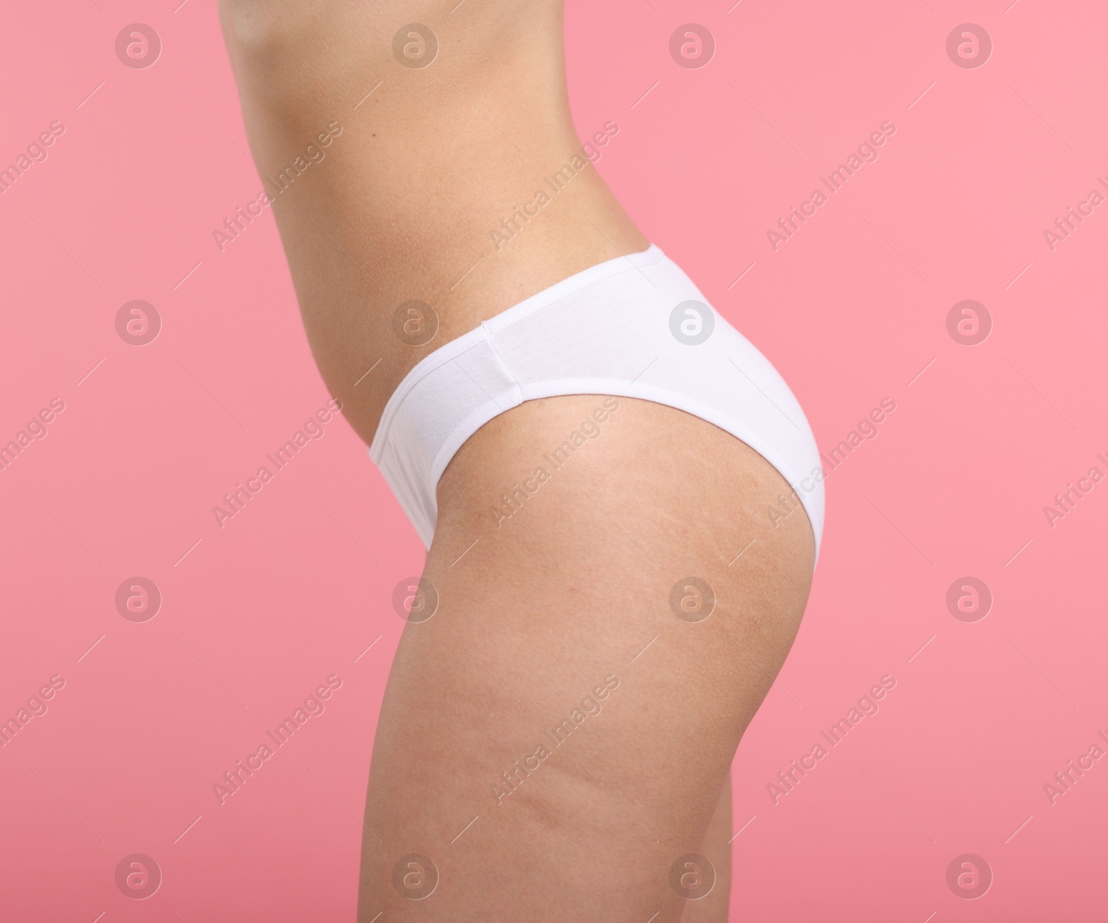 Woman with perfect slim body on pink background, closeup Photo of Woman with perfect slim body on pink background, closeup